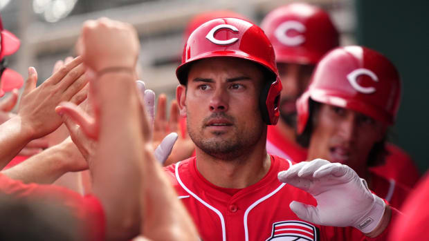Cincinnati Reds catcher Luke Maile, center, is congratulated in the dugout after hitting a three-run home run in the third inning during a MLB spring training baseball game, Sunday, Feb. 25, 2024, at Goodyear Ballpark in Goodyear, Ariz.  